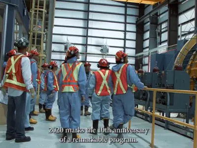 screenshot of video showing people touring an underground mine